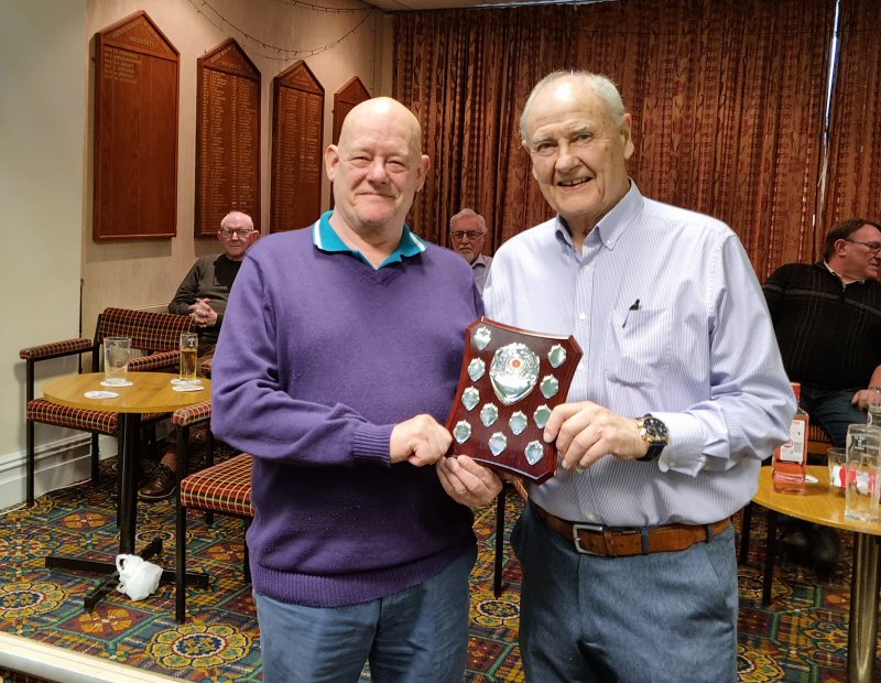 Captain of Lostock Cons. Mike Lonsdale, receives the Chairman's Shield Trophy from Chairman John Hilton